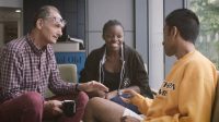 Two students sat in reception of BOVTS talking to a tutor