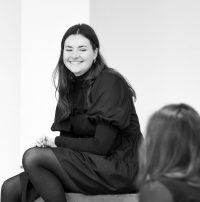 Black and white photo of acting student sat down