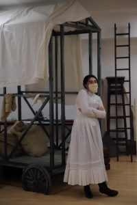 Female acting student standing next to props