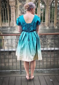 From behind shot of model wearing blue and white dress