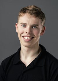 Headshot of a smiling man with short blonde cropped hair