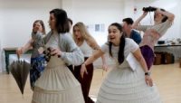 Actors in rehearsals, some in Edwardian costume