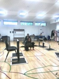 Two actors knelt on the floor in rehearsals