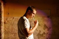 Side view of actor with unlit cigarette in his mouth